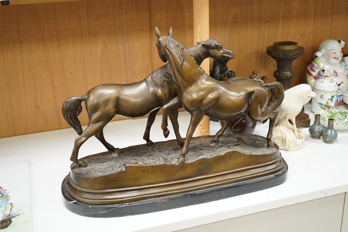 After Pierre-Jules Mêne (1810-1879), a large animalier bronze of two horses, raised on shaped base, 55cm wide